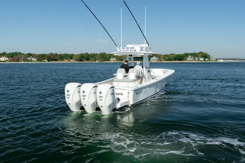 Slide: The Image of 2022 Regulator 34 CC on calm water with four outboard engines. - 7