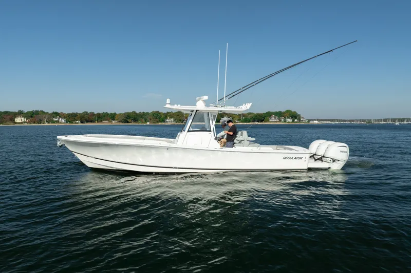 Slide: The Image of A white boat on calm water, featuring two outboard engines and a person at the helm. - 4