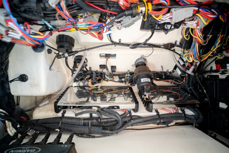Slide: The Image of Electrical wiring and components inside a boat, featuring various cables and devices. - 37