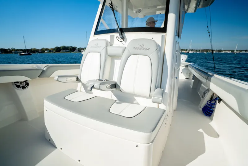 Slide: The Image of The image shows the cockpit of a 2022 Regulator 34 CC boat with white seating. - 22