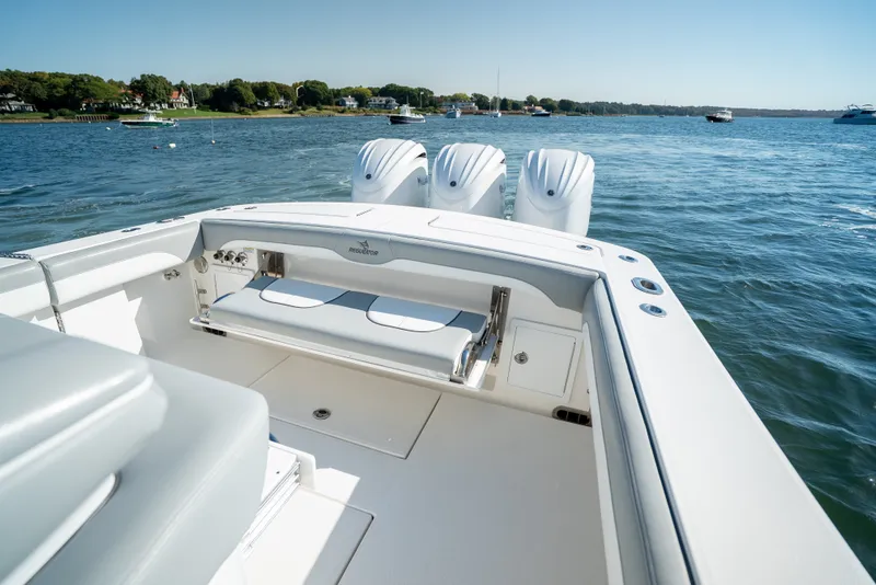 Slide: The Image of The image shows a modern boat on calm water with three outboard engines and a bench seat. - 29