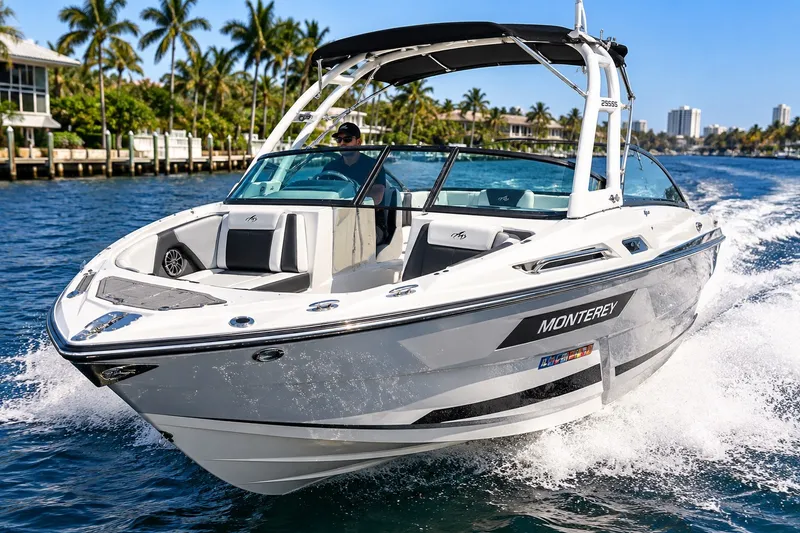 The Image of 2022 Monterey 255SS Super Sport boat cruising on a sunny day with palm trees in the background. - 0