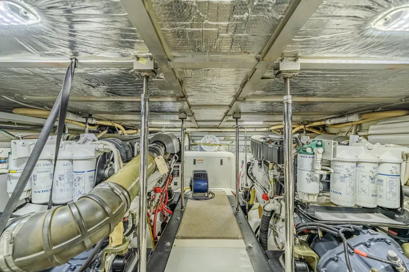 Slide: The Image of Engine room of a 2006 Carver 56 Voyager yacht, showcasing mechanical components. - 78