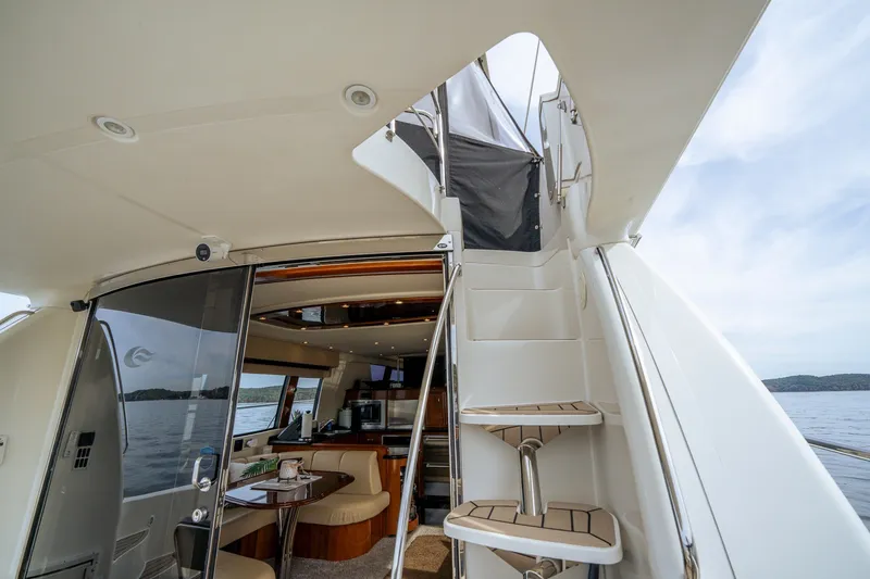 Slide: The Image of 2006 Carver 56 Voyager yacht interior with staircase and seating area. - 27