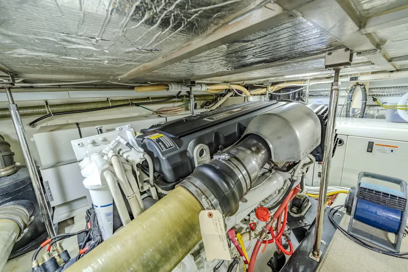 Slide: The Image of Engine room of a 2006 Carver 56 Voyager yacht, showcasing detailed machinery and components. - 72