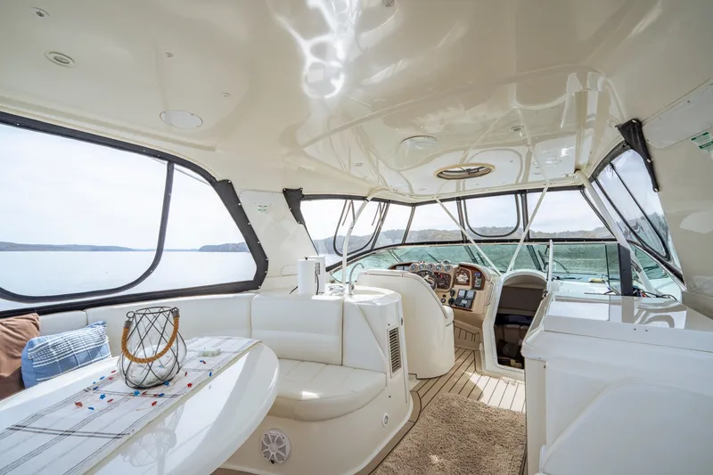 Slide: The Image of Luxurious interior of 2006 Carver 56 Voyager yacht with panoramic windows and elegant seating. - 50