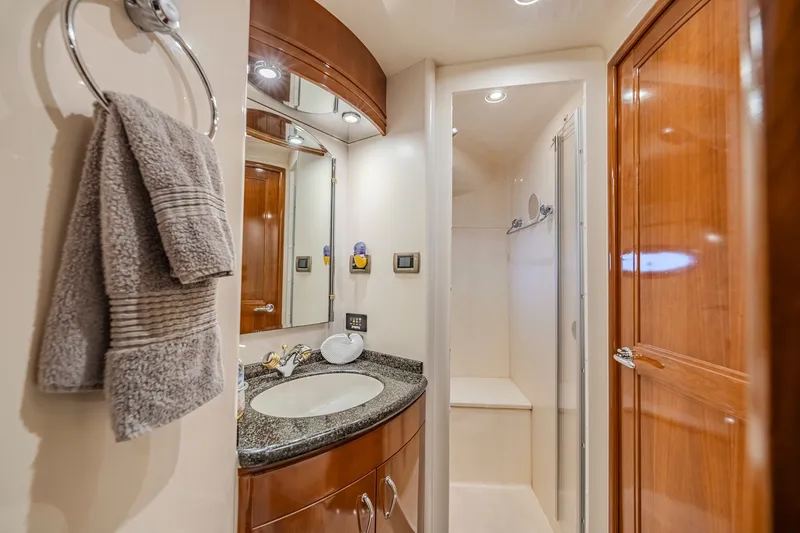 Slide: The Image of Luxurious bathroom in 2006 Carver 56 Voyager yacht with modern fixtures and wooden cabinetry. - 65