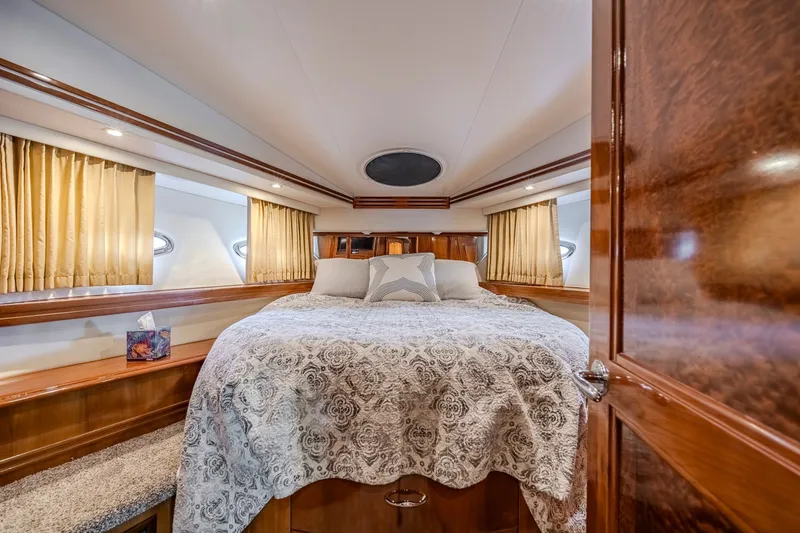 Slide: The Image of Luxurious bedroom interior of 2006 Carver 56 Voyager yacht with elegant bedding and wood accents. - 67