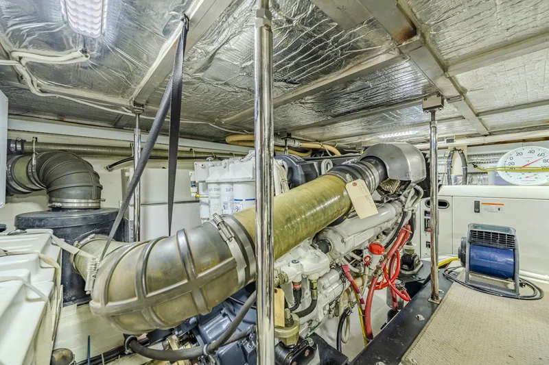 Slide: The Image of Engine room of a 2006 Carver 56 Voyager yacht, showcasing mechanical components. - 76