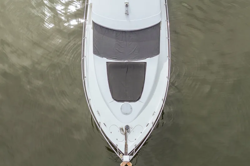 Slide: The Image of Top view of a 2006 Carver 56 Voyager yacht on calm water. - 13
