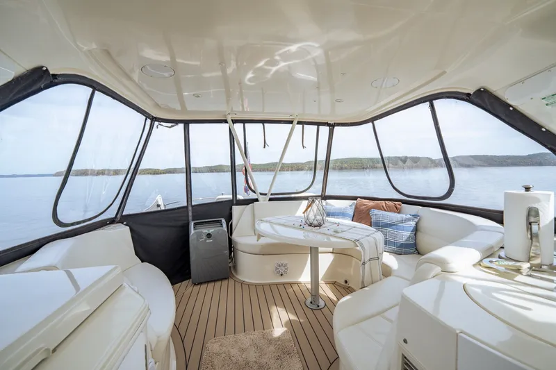 Slide: The Image of Luxurious interior of 2006 Carver 56 Voyager yacht with panoramic windows and elegant seating. - 51