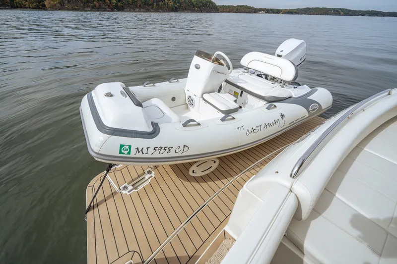 Slide: The Image of Inflatable boat on Carver 56 Voyager yacht deck, 2006 model, on calm water. - 26