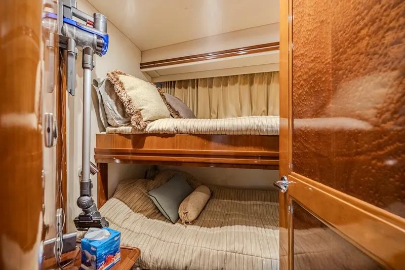 Slide: The Image of Cozy cabin interior of 2006 Carver 56 Voyager yacht with bunk beds and elegant wood finish. - 70