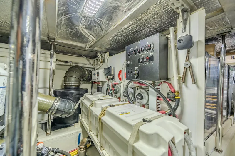 Slide: The Image of Engine room of 2006 Carver 56 Voyager yacht with control panel and machinery. - 75