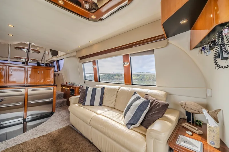 Slide: The Image of Luxurious interior of a 2006 Carver 56 Voyager yacht with plush seating and elegant wood finishes. - 35
