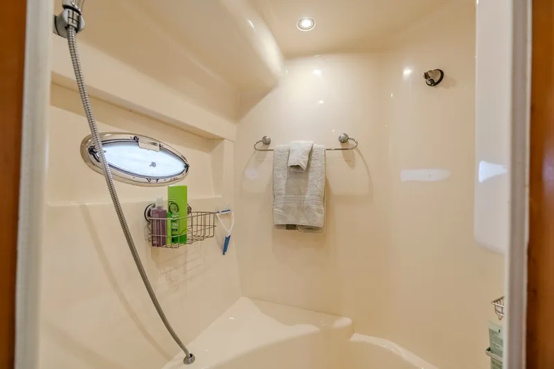 Slide: The Image of Luxurious bathroom in 2006 Carver 56 Voyager yacht with shower and porthole window. - 62