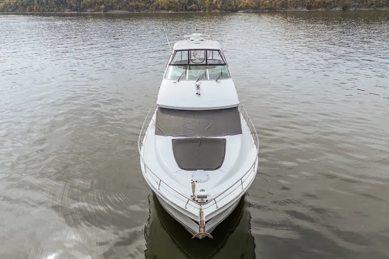Slide: The Image of 2006 Carver 56 Voyager yacht on calm water, front view. - 20