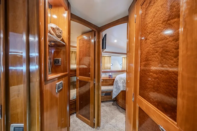 Slide: The Image of Luxurious interior of 2006 Carver 56 Voyager yacht with polished wood finishes and cozy bedroom. - 63