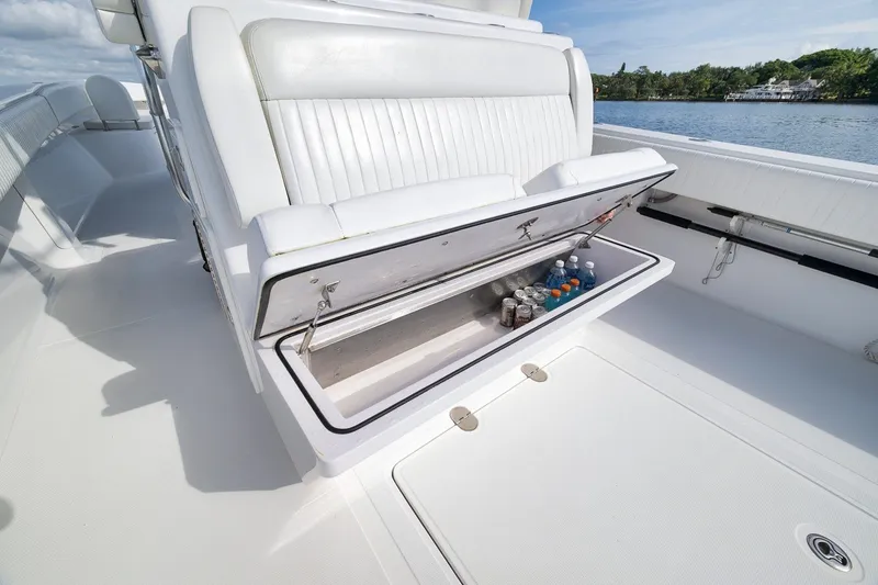 Slide: The Image of 2020 Bahama 41 boat with open storage compartment, stocked with beverages, on a sunny day. - 57