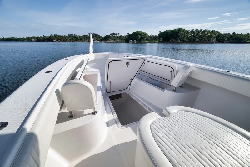 Slide: The Image of 2020 Bahama 41 boat interior with open storage, white seating, and scenic water view. - 47