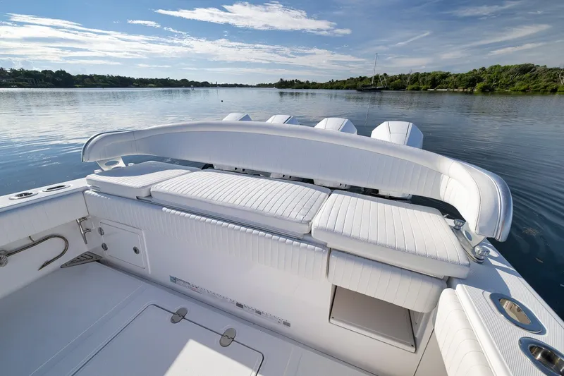 Slide: The Image of 2020 Bahama 41 boat with white seating, overlooking calm waters and clear sky. - 39