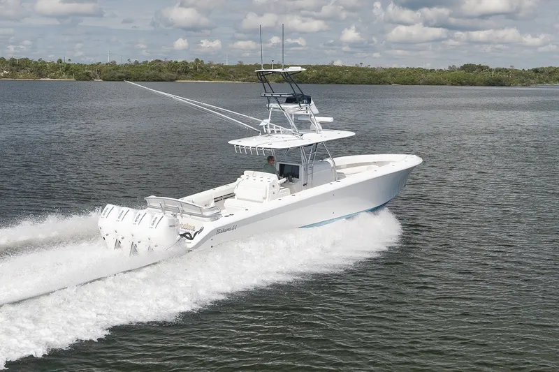 Slide: The Image of 2020 Bahama 41 boat cruising on a calm lake under a cloudy sky. - 16