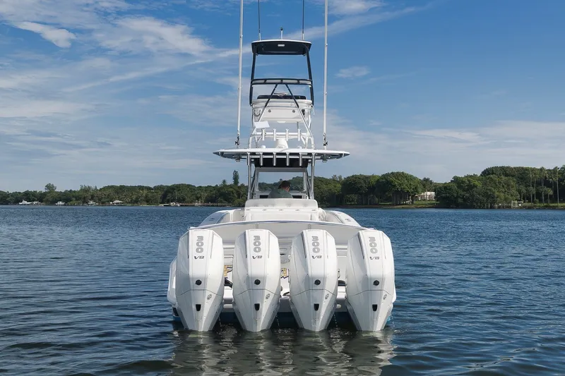 Slide: The Image of 2020 Bahama 41 boat with four powerful V8 engines on a calm lake. - 7