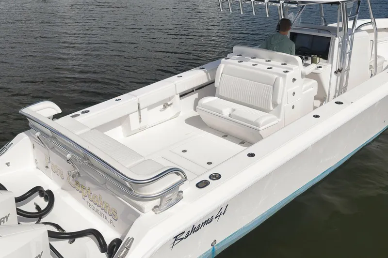 Slide: The Image of 2020 Bahama 41 boat with white seating and sleek design on calm water. - 31