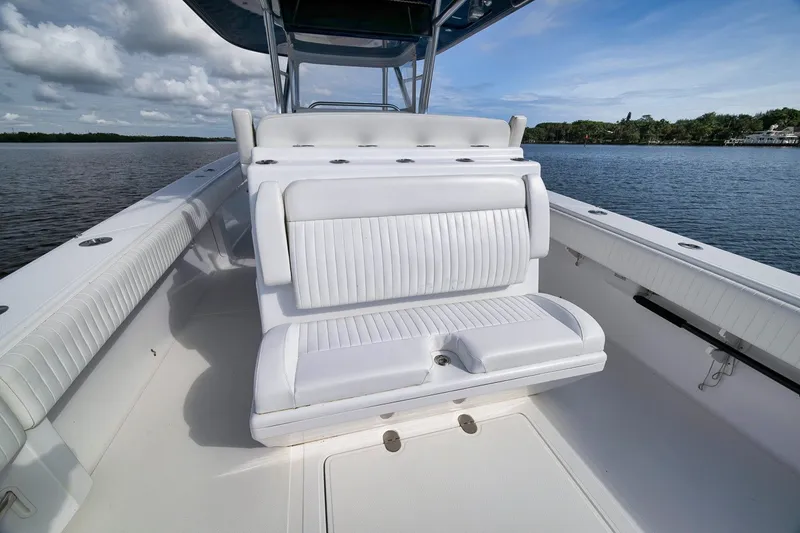 Slide: The Image of 2020 Bahama 41 boat interior with white seating, on calm water. - 56