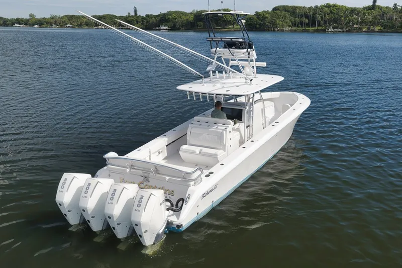 Slide: The Image of 2020 Bahama 41 boat with quad engines cruising on a serene lake. - 5