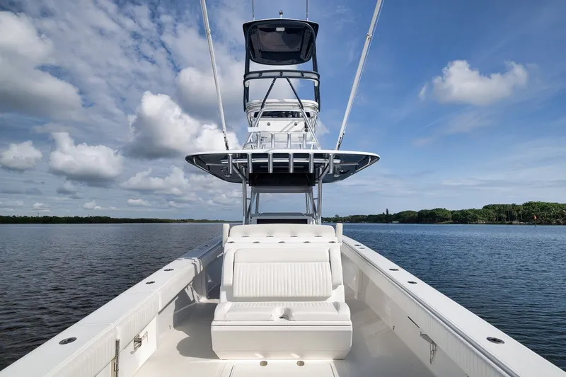 Slide: The Image of 2020 Bahama 41 boat on calm water under a blue sky with clouds. - 55