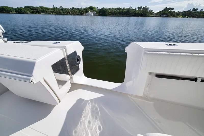 Slide: The Image of 2020 Bahama 41 boat deck overlooking serene lake and lush shoreline. - 65