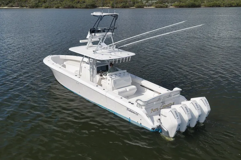 Slide: The Image of 2020 Bahama 41 boat with four outboard engines on calm water. - 13