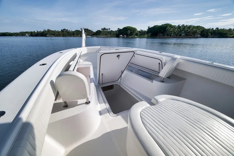 Slide: The Image of 2020 Bahama 41 boat interior with open storage, white seating, and scenic water view. - 46