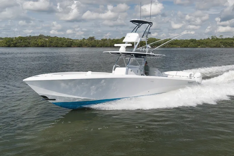 Slide: The Image of 2020 Bahama 41 boat cruising on a calm river under a cloudy sky. - 22