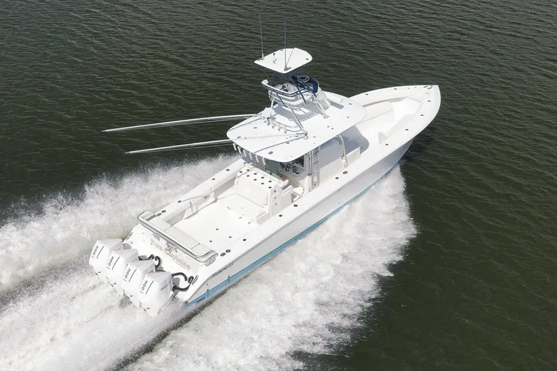 Slide: The Image of 2020 Bahama 41 boat cruising on water with triple outboard engines. - 14