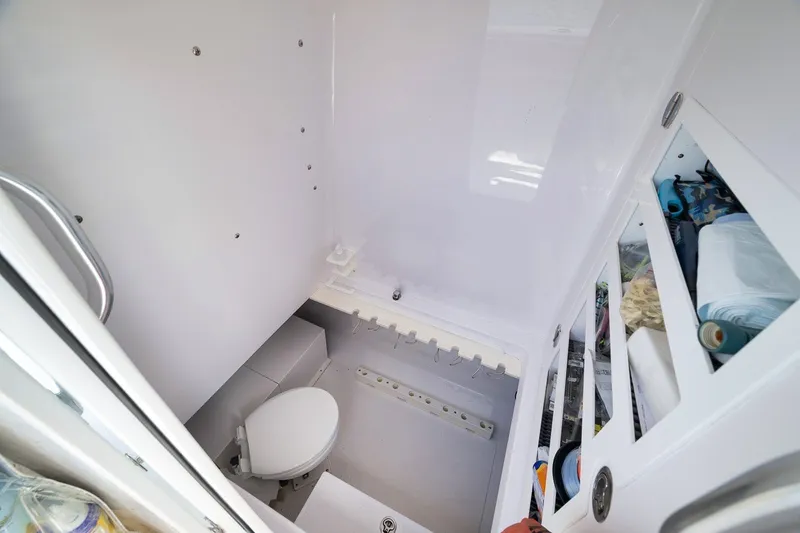 Slide: The Image of Compact bathroom in 2020 Bahama 41 boat, featuring a toilet and storage shelves. - 58