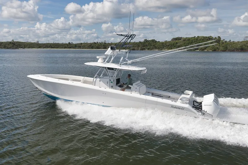 Slide: The Image of 2020 Bahama 41 boat cruising on water under a partly cloudy sky. - 23
