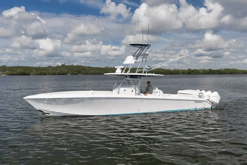 Slide: The Image of 2020 Bahama 41 boat on calm water under a cloudy sky. - 10
