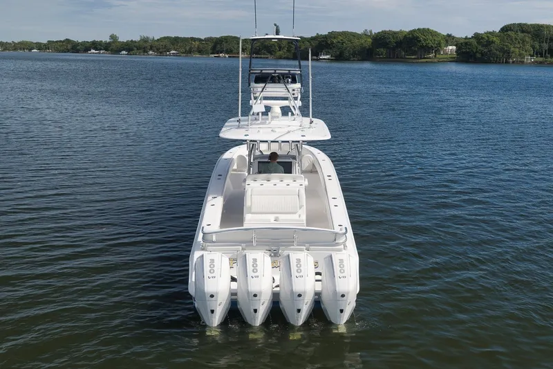 Slide: The Image of 2020 Bahama 41 boat with four engines on a calm lake. - 8