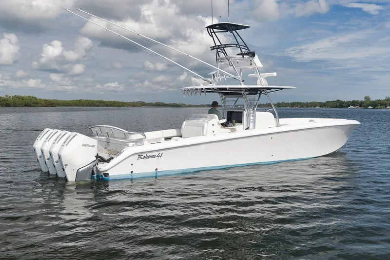 Slide: The Image of 2020 Bahama 41 boat with multiple Mercury engines on calm water. - 6