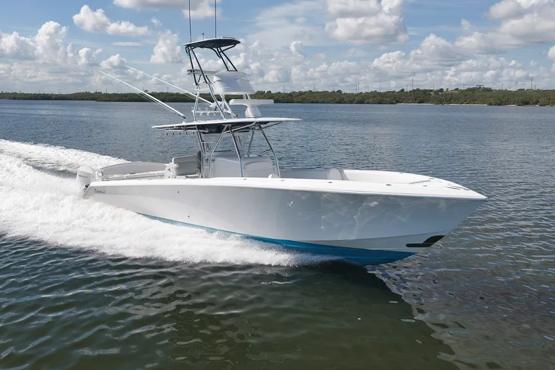 Slide: The Image of 2020 Bahama 41 boat cruising on a calm lake under a partly cloudy sky. - 18