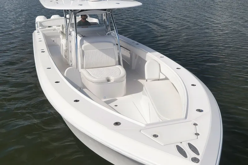 Slide: The Image of 2020 Bahama 41 boat on water, featuring sleek white design and spacious seating. - 25
