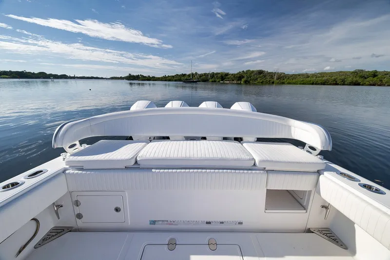 Slide: The Image of 2020 Bahama 41 boat interior with white seating on calm water. - 40
