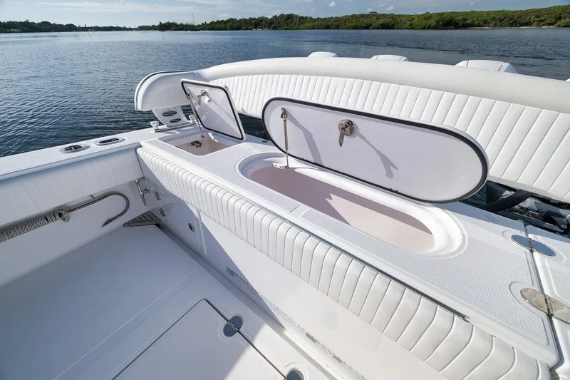 Slide: The Image of 2020 Bahama 41 boat interior with open storage compartments on a calm lake. - 42