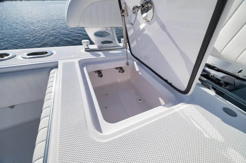 Slide: The Image of Open storage compartment on a 2020 Bahama 41 boat, with water in the background. - 44