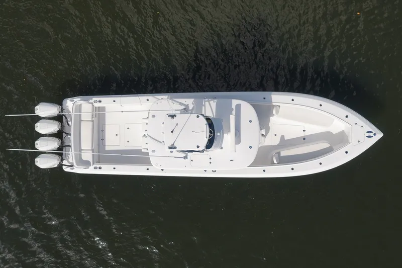 Slide: The Image of Aerial view of 2020 Bahama 41 boat with triple outboard engines on water. - 9