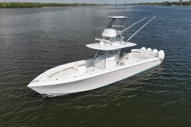 Slide: The Image of 2020 Bahama 41 boat on calm water, featuring sleek design and multiple engines. - 12