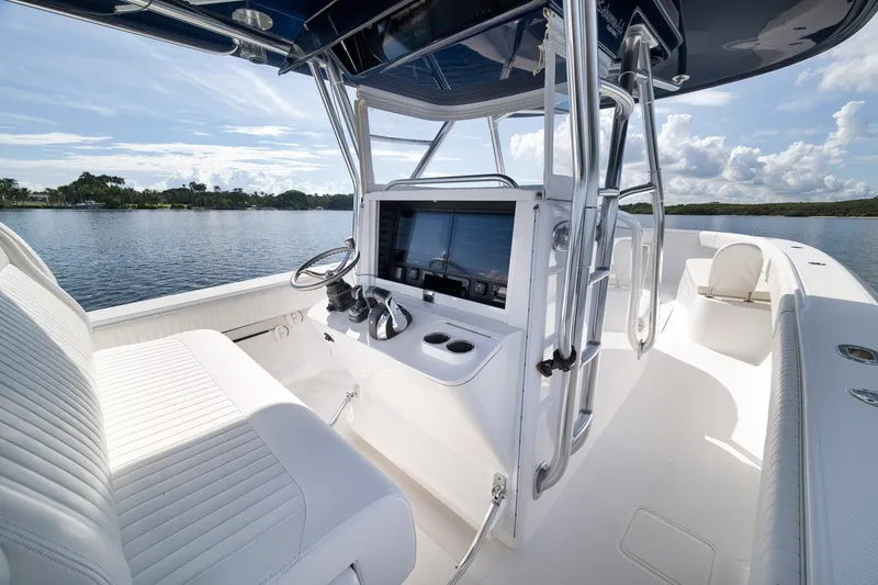 Slide: The Image of 2020 Bahama 41 boat interior with sleek white seating and advanced navigation system. - 61