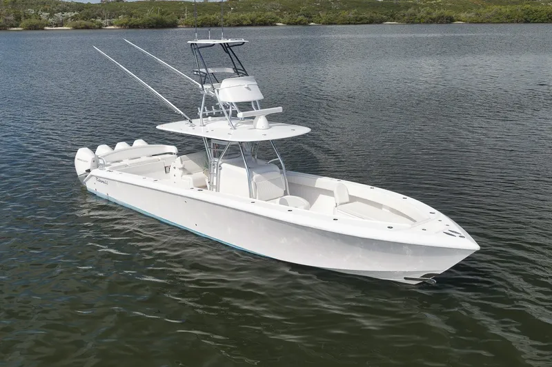 Slide: The Image of 2020 Bahama 41 boat on calm water, featuring sleek design and multiple engines. - 4